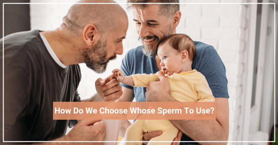 two dads holding infant