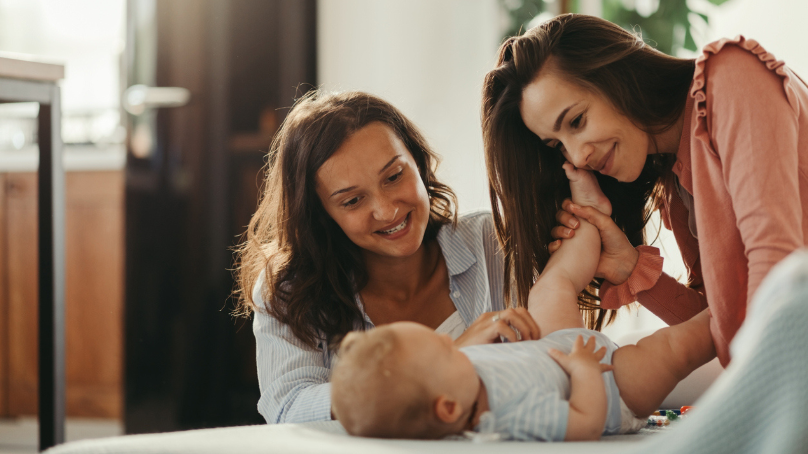 two moms with baby